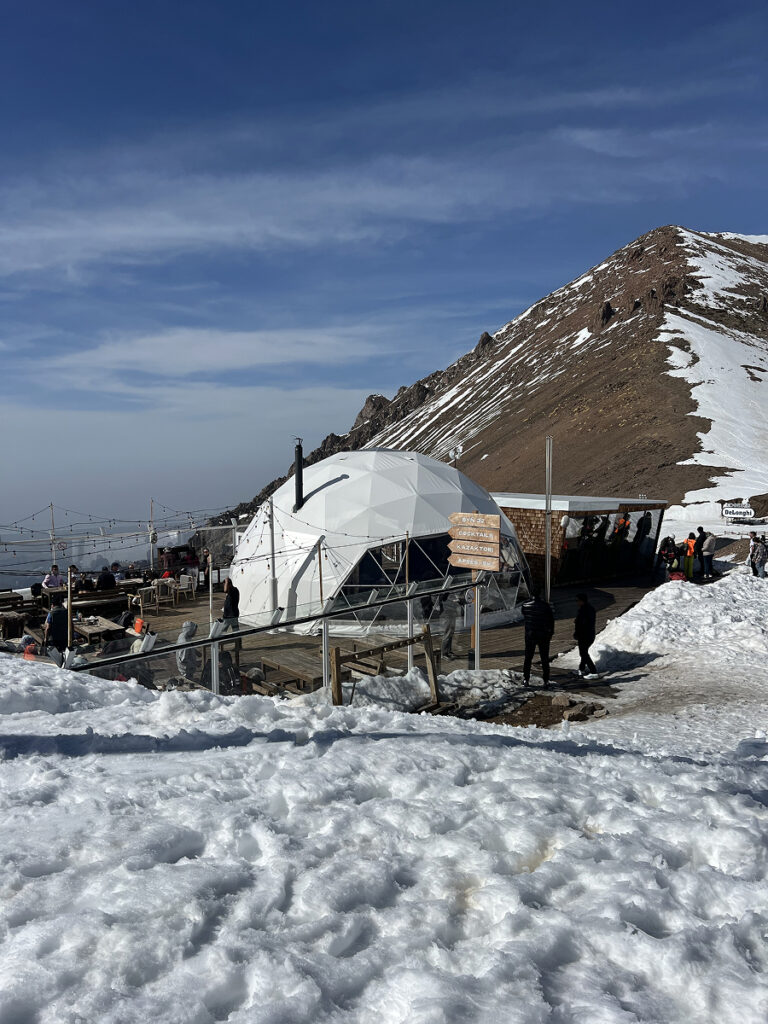 Exterior view of Syn32, the dome-shaped restaurant at Talgar Pass, surrounded by snow at 3,200 m in Shymbulak