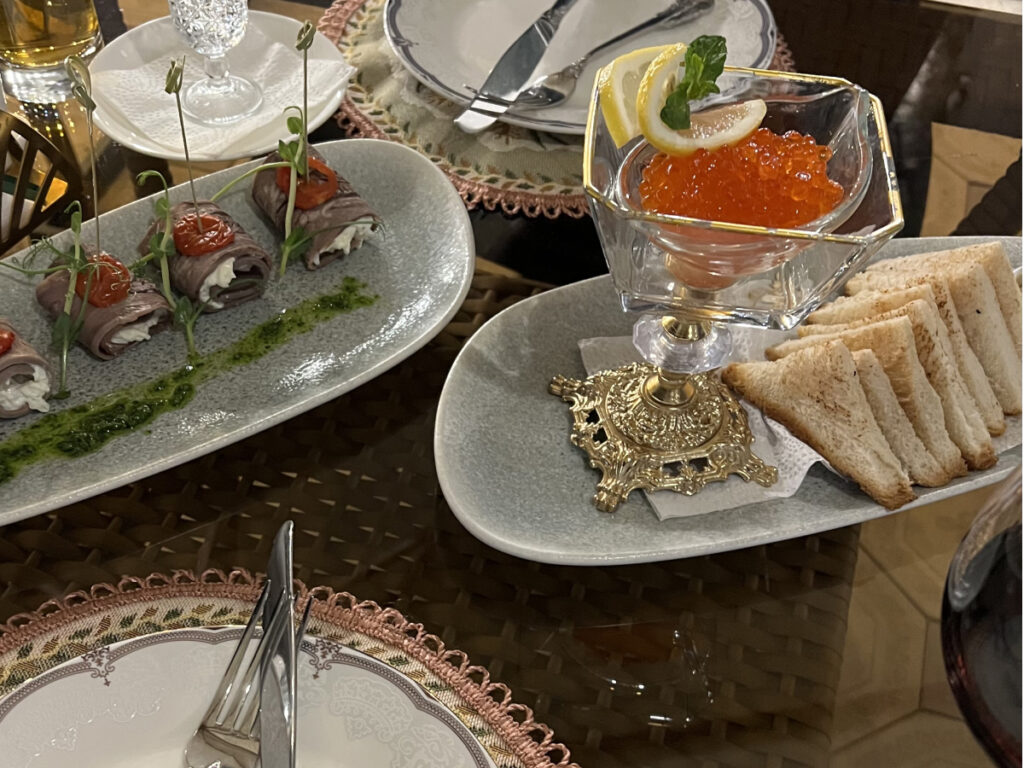 Caviar and appetizers served on elegant platters at Daredzhani Kunayeva, a Russian restaurant in Almaty