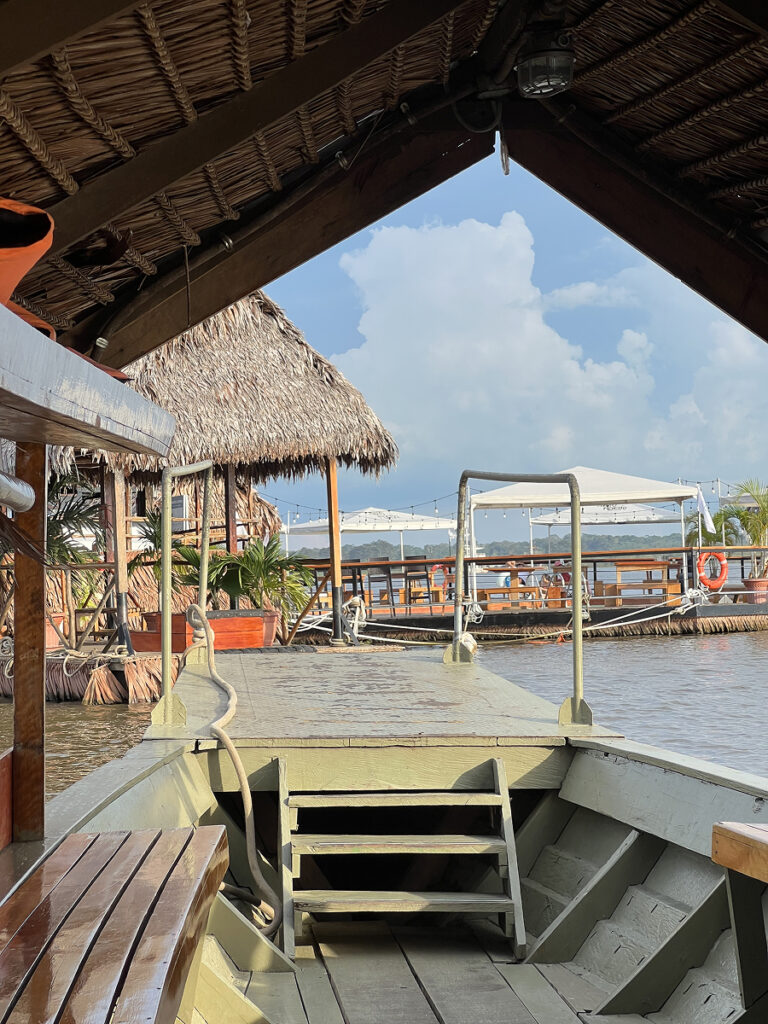 Arriving by boat to Al Frio y Al Fuego floating restaurant in Iquitos, Peru