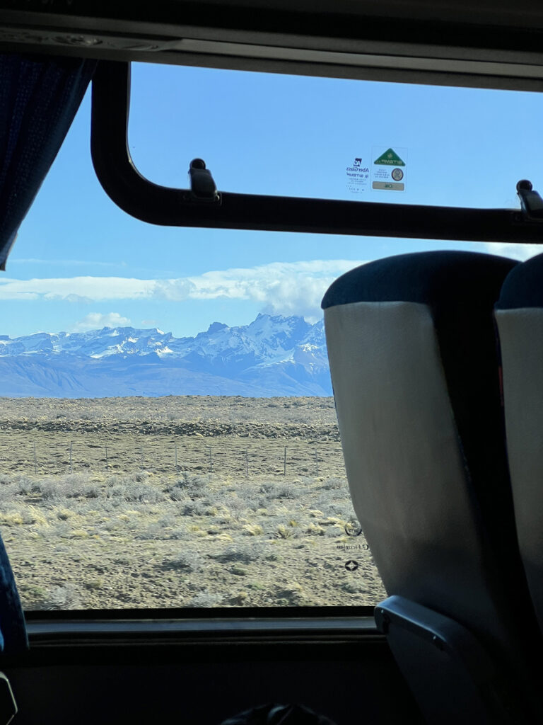 Mountain view through a bus window on the way to El Chaltén, Argentina, with Patagonian steppe in the foreground