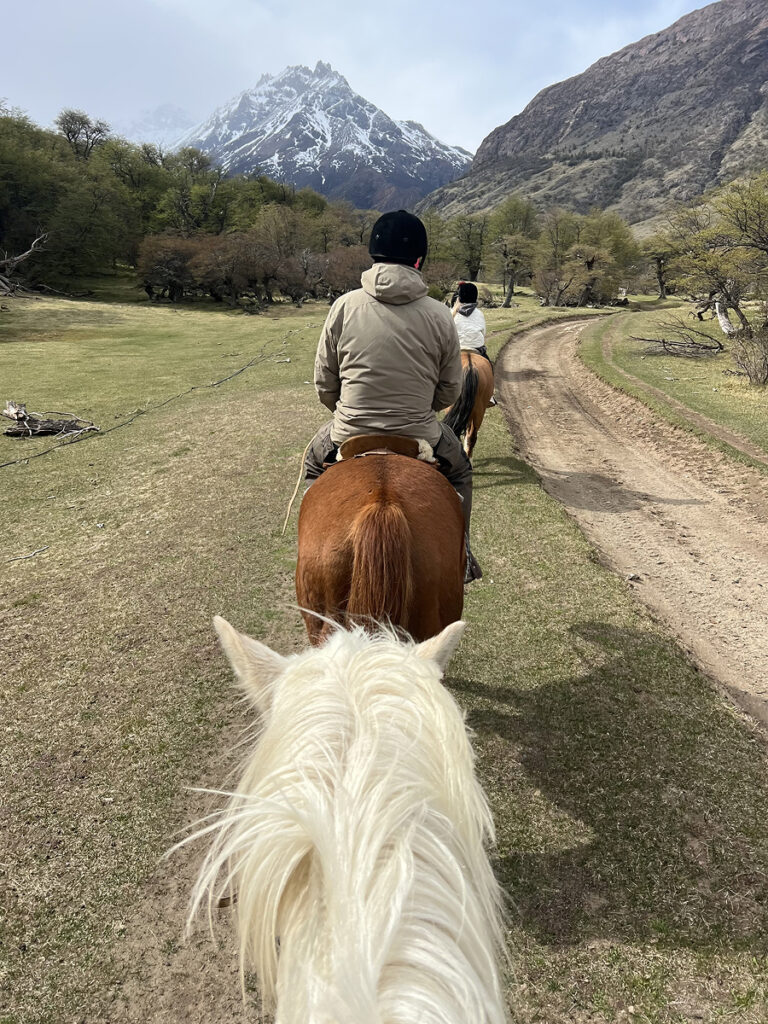 Horseback riding in El Chaltén along a Patagonian trail with mountain views, seen from the rider’s perspective