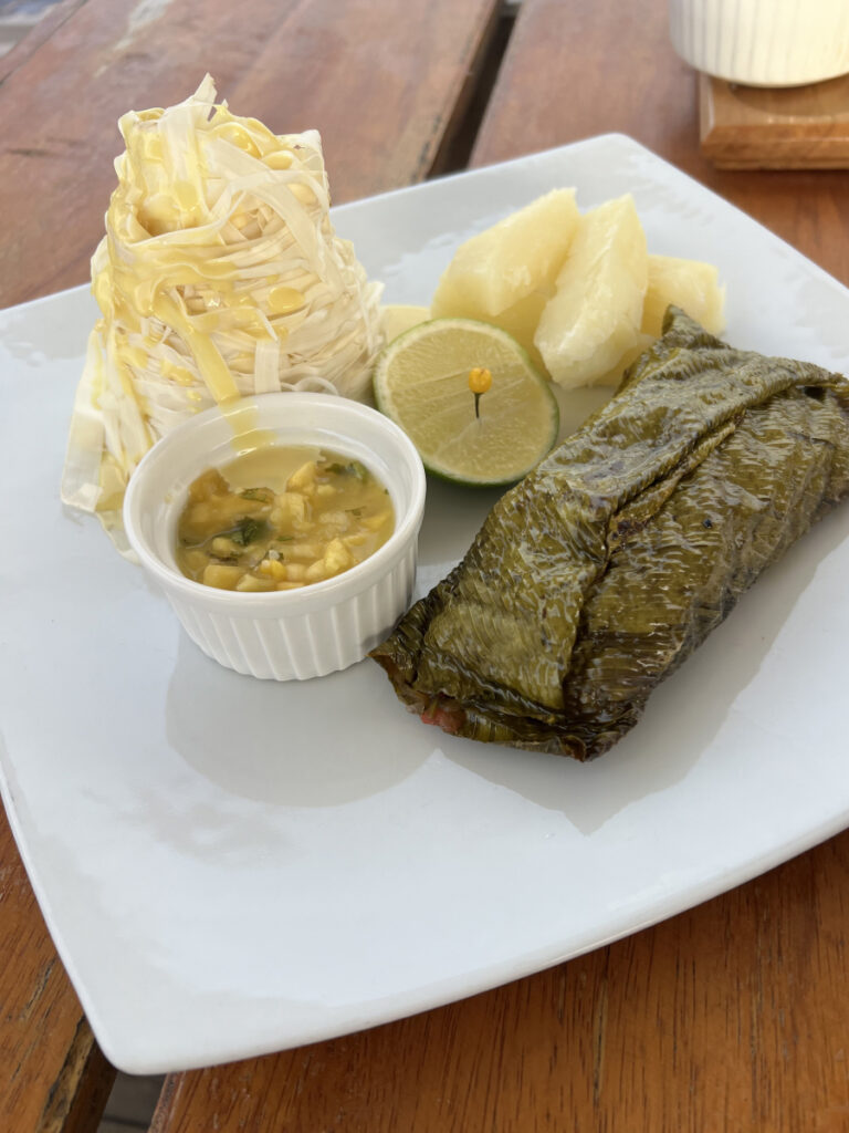 Tamale served with salad and passion fruit sauce at Al Frio y Al Fuego restaurant in Iquitos, Peru